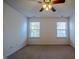 Spacious bedroom with two windows and ceiling fan at 2 Woodsage Ln, Durham, NC 27713