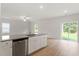 Open concept kitchen with island and view of backyard at 207 Shelfit Trl, Oxford, NC 27565