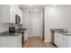 White kitchen cabinets, granite countertops, and stainless steel appliances at 207 Shelfit Trl, Oxford, NC 27565
