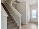 Modern staircase with neutral carpeting and wooden handrail at 207 Shelfit Trl, Oxford, NC 27565