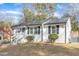 Charming white house with gray door, landscaping, and a spacious yard at 2223 Shannon St, Raleigh, NC 27610