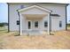 A covered back porch with white columns on an unfinished lot at 223 Johnson Ridge Way, Four Oaks, NC 27524
