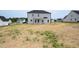 View of the back of a house with a covered porch and newly seeded backyard at 223 Johnson Ridge Way, Four Oaks, NC 27524