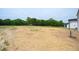 A flat, spacious backyard with freshly laid straw for new landscaping at 223 Johnson Ridge Way, Four Oaks, NC 27524