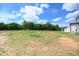 Large backyard with newly built house in background and trees at 223 Johnson Ridge Way, Four Oaks, NC 27524