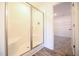 Shower featuring white tile surround, glass door, and access to the walk-in closet at 223 Johnson Ridge Way, Four Oaks, NC 27524