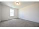 Bright bedroom with a large window and plush gray carpeting at 223 Johnson Ridge Way, Four Oaks, NC 27524