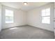 Cozy bedroom with two bright windows and neutral carpeting at 223 Johnson Ridge Way, Four Oaks, NC 27524