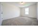 Bedroom features large window and neutral carpet at 223 Johnson Ridge Way, Four Oaks, NC 27524