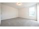 Sun-filled bedroom with large windows and neutral carpeting at 223 Johnson Ridge Way, Four Oaks, NC 27524