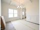 Elegant dining room with coffered ceilings, large windows, and contemporary chandelier at 223 Johnson Ridge Way, Four Oaks, NC 27524