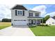 Beautiful two-story home with a two-car garage, manicured lawn, and craftsman-style details at 223 Johnson Ridge Way, Four Oaks, NC 27524