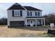 Inviting two-story home featuring a covered porch and attached garage at 223 Johnson Ridge Way, Four Oaks, NC 27524