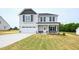 Inviting two-story home featuring a two-car garage and a well-maintained lawn at 223 Johnson Ridge Way, Four Oaks, NC 27524