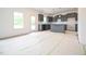 Modern kitchen featuring dark cabinets, a center island, and abundant natural light at 223 Johnson Ridge Way, Four Oaks, NC 27524