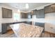 Modern kitchen features gray cabinets, granite countertops, stainless steel sink, and white subway tile backsplash at 223 Johnson Ridge Way, Four Oaks, NC 27524