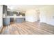 Modern kitchen with gray cabinets, island, and open access to the entry at 223 Johnson Ridge Way, Four Oaks, NC 27524