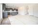 Unfinished kitchen with gray cabinets, island, and white subway tile backsplash, ready for finishing touches at 223 Johnson Ridge Way, Four Oaks, NC 27524
