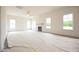 Expansive living room featuring a fireplace, large windows and lots of natural light at 223 Johnson Ridge Way, Four Oaks, NC 27524