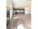 Open floor plan highlighting modern kitchen and living room with wood floors at 223 Johnson Ridge Way, Four Oaks, NC 27524