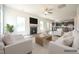Open-concept living room with fireplace, TV, and seating at 223 Johnson Ridge Way, Four Oaks, NC 27524