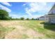 Expansive backyard with lush grass, surrounded by mature trees and a clear blue sky at 236 Johnson Ridge Way, Four Oaks, NC 27524