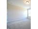 A bedroom with neutral walls, soft carpet flooring, and a window at 236 Johnson Ridge Way, Four Oaks, NC 27524