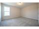 Bright bedroom with a window, soft carpet flooring, and neutral walls at 236 Johnson Ridge Way, Four Oaks, NC 27524