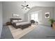 Large bedroom featuring a vaulted ceiling, fan, and neutral decor at 236 Johnson Ridge Way, Four Oaks, NC 27524