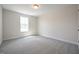 Bright bedroom featuring neutral walls, carpet flooring, and a window for natural light at 236 Johnson Ridge Way, Four Oaks, NC 27524