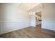 Dining room with hardwood floors, wainscoting, coffered ceilings, and an open view into the kitchen at 236 Johnson Ridge Way, Four Oaks, NC 27524