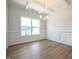 Bright dining room with wainscoting, coffered ceilings, and hardwood floors at 236 Johnson Ridge Way, Four Oaks, NC 27524