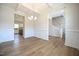 Dining room with hardwood floors, wainscoting, and an open view to the staircase and kitchen at 236 Johnson Ridge Way, Four Oaks, NC 27524