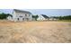 Exterior view of a new construction home on a large lot in a neighborhood of similar homes at 236 Johnson Ridge Way, Four Oaks, NC 27524