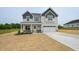 Charming two-story home featuring a covered porch and attached two-car garage at 236 Johnson Ridge Way, Four Oaks, NC 27524