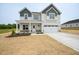 Inviting two-story home boasting a covered front porch and attached two-car garage at 236 Johnson Ridge Way, Four Oaks, NC 27524
