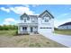 Charming two-story home with a two-car garage, landscaped front yard, and covered front porch entrance at 236 Johnson Ridge Way, Four Oaks, NC 27524