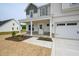 Welcoming covered porch with stone accents and white columns on a charming home at 236 Johnson Ridge Way, Four Oaks, NC 27524
