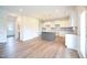 Open kitchen with white cabinetry, granite countertops, stainless appliances, and a gray island at 236 Johnson Ridge Way, Four Oaks, NC 27524