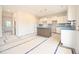 Modern kitchen featuring an island and white cabinets, awaiting finishing touches at 236 Johnson Ridge Way, Four Oaks, NC 27524