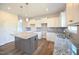 Bright kitchen featuring granite counters, stainless sink, kitchen island and white cabinets at 236 Johnson Ridge Way, Four Oaks, NC 27524