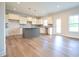 Modern kitchen with white cabinets, gray backsplash, granite countertops and a gray island at 236 Johnson Ridge Way, Four Oaks, NC 27524