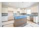 Well-lit kitchen with an island, white cabinets, and modern finishes at 236 Johnson Ridge Way, Four Oaks, NC 27524