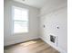 Bright laundry room with a window, vinyl flooring, and washer/dryer hookups at 236 Johnson Ridge Way, Four Oaks, NC 27524