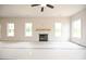 Bright living room featuring a cozy fireplace and ample natural light from large windows at 236 Johnson Ridge Way, Four Oaks, NC 27524