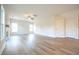 Open living room area with hardwood floors, ceiling fan, and views to entry way and upstairs at 236 Johnson Ridge Way, Four Oaks, NC 27524