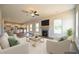Spacious living room open to kitchen with fireplace, ceiling fan, and ample natural light at 236 Johnson Ridge Way, Four Oaks, NC 27524