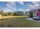 This backyard features a screened porch and an open green space, perfect for gatherings and outdoor fun at 2407 Cattail Pond Dr, Zebulon, NC 27597