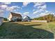 Expansive backyard with lush lawn, complemented by a classic fence and screened porch perfect for outdoor enjoyment at 2407 Cattail Pond Dr, Zebulon, NC 27597