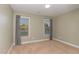 This empty bedroom has neutral colored walls and carpeting and two large windows at 2407 Cattail Pond Dr, Zebulon, NC 27597